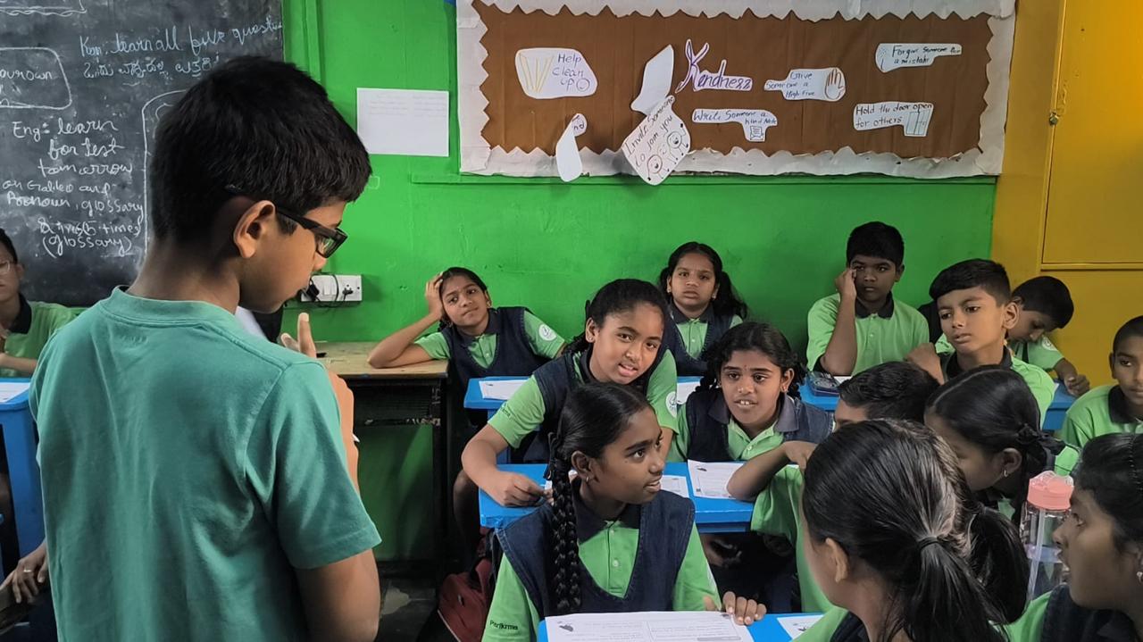 Vanij mid-explanation with the class watching from their desks