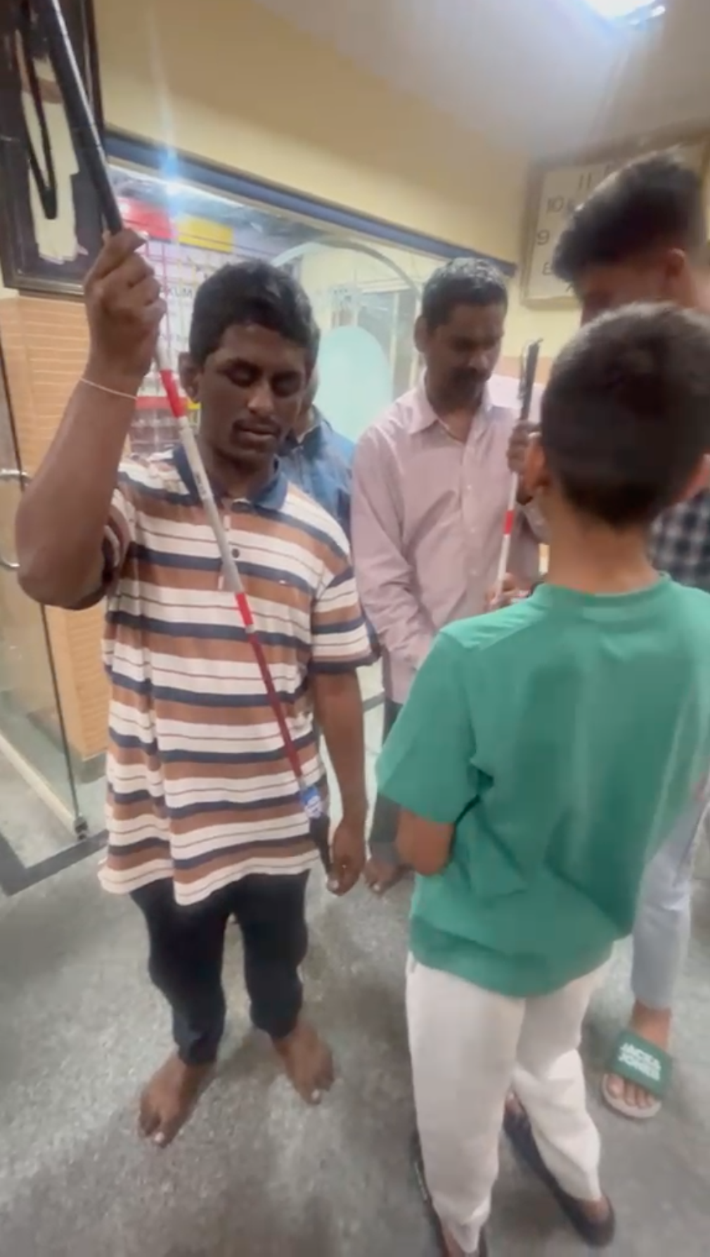 A student at Sri Rakum School for the Blind holding one of the donated smart blind sticks